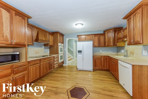 a kitchen with wooden cabinets and white appliances