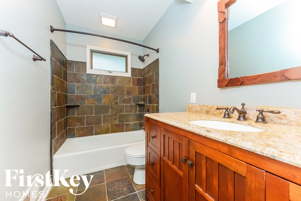 one of two bathrooms in the guest bathroom with shower and sink