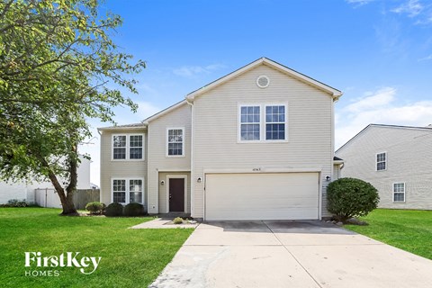 A two-story house with a garage is for sale.