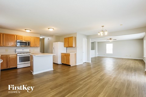 A kitchen with wooden cabinets and a white island.