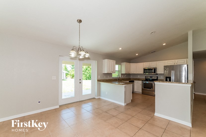 a large kitchen with a door to the backyard
