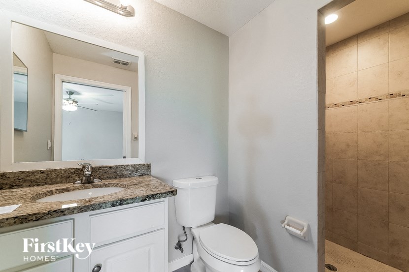 a bathroom with a toilet and a sink and a mirror