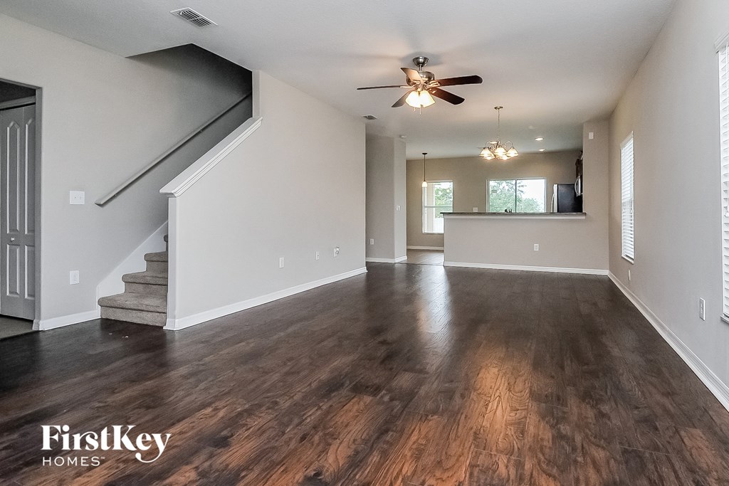 the living room and dining room with hardwood flooring