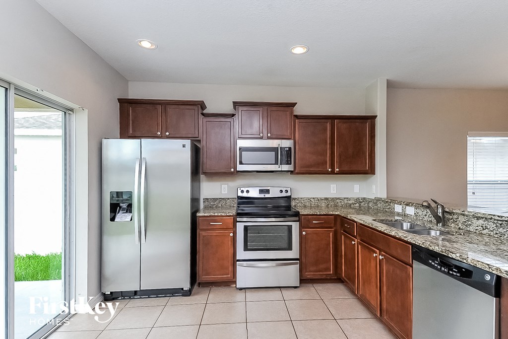 a kitchen with stainless steel appliances and wooden cabinets