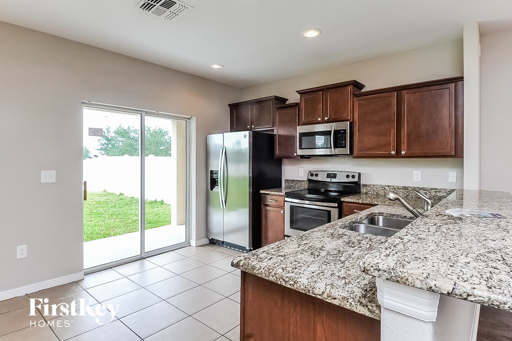 a kitchen with stainless steel appliances and granite counter tops