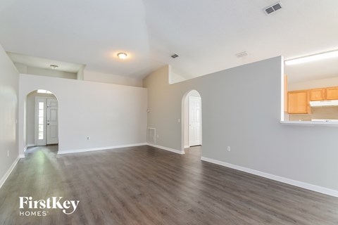 a living room with white walls and a wooden floor