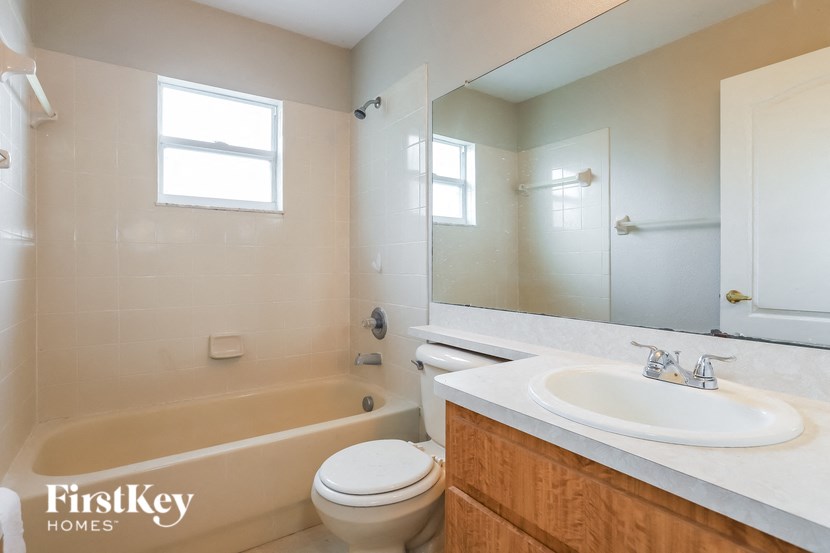 a bathroom with a sink toilet and a bath tub