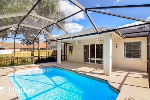 A pool under a shade sail in a home.