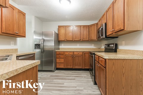 a kitchen with wooden cabinets and stainless steel appliances