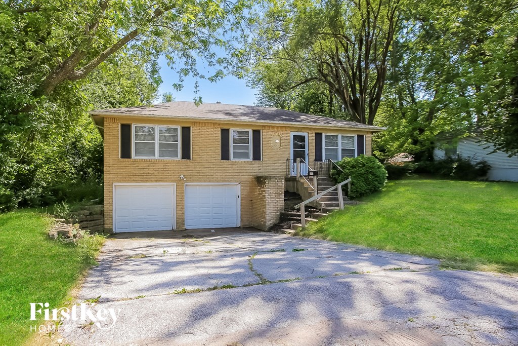 A two-car garage with a brick exterior and a white door.