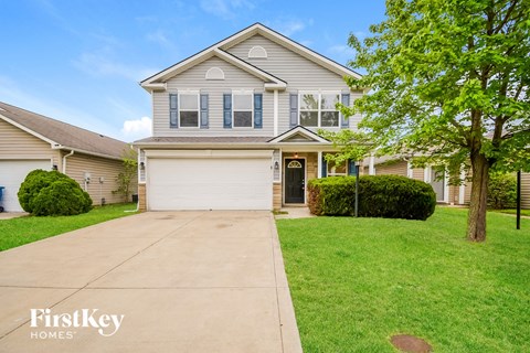 A two-story house with a garage is for sale.