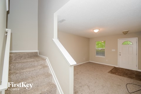 A room with a staircase and a door.