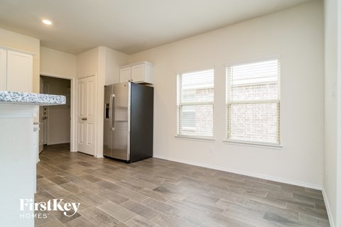 A kitchen with a fridge and a counter top.