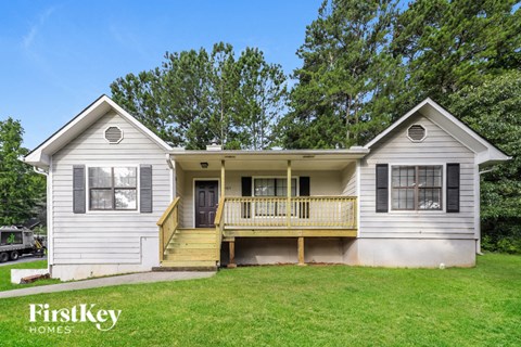 A two-story house with a porch and a garage.