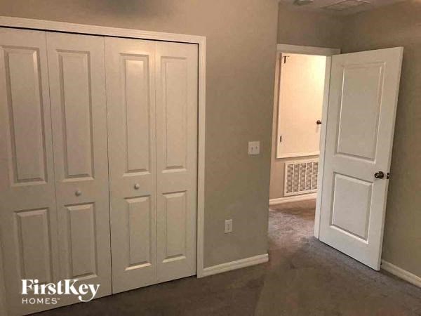 A room with white doors and a carpeted floor.