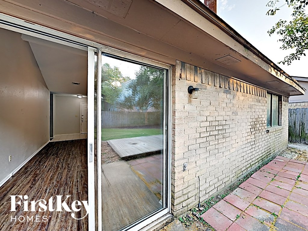 a house with a sliding glass door and a backyard