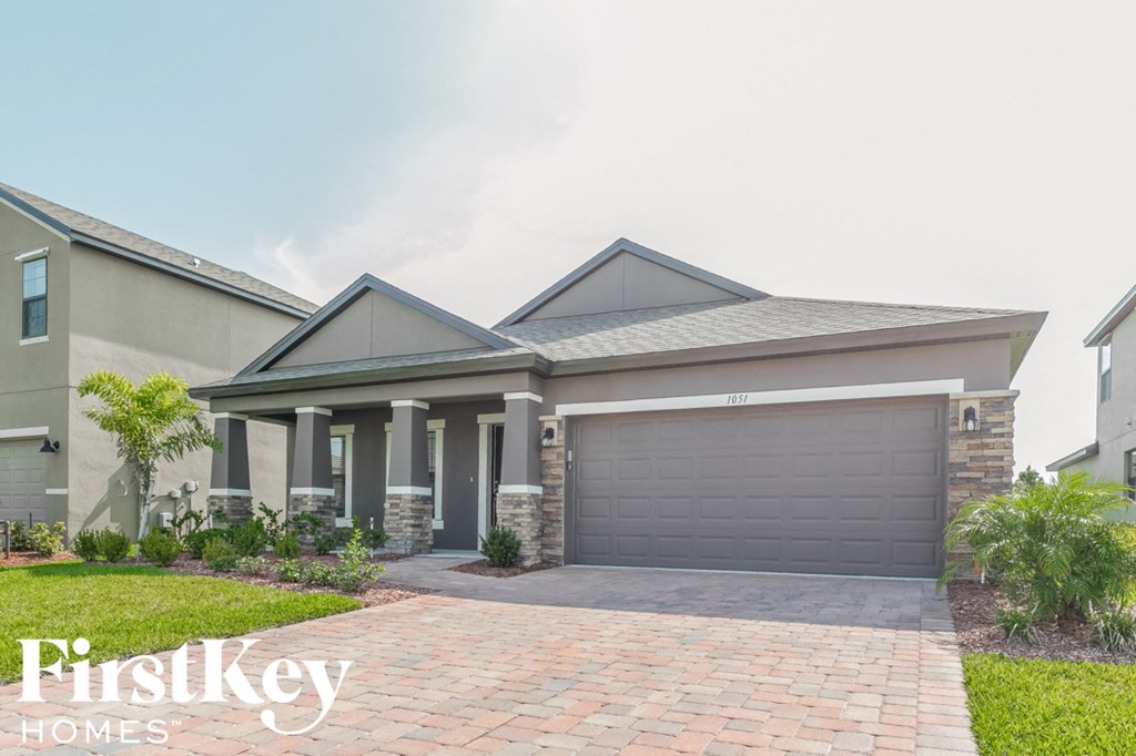 a house with a driveway and a garage door
