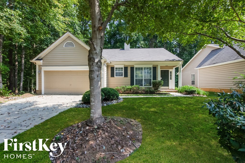 a home with a tree in the front yard