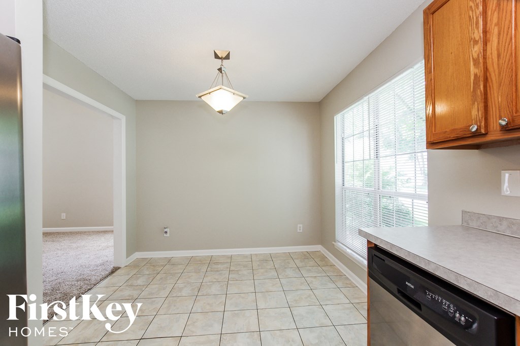 a kitchen and dining room with a large window