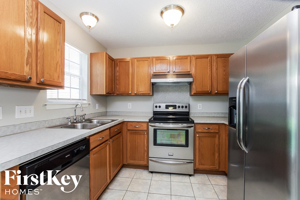 a kitchen with wooden cabinets and stainless steel appliances
