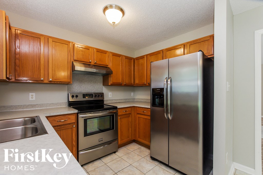 a kitchen with stainless steel appliances and wooden cabinets
