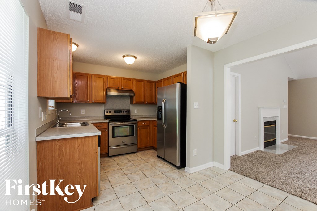 a kitchen with stainless steel appliances and wooden cabinets