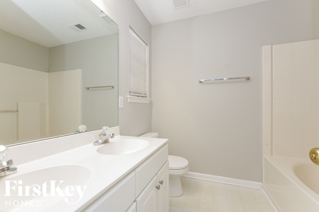 a white bathroom with a sink and a toilet