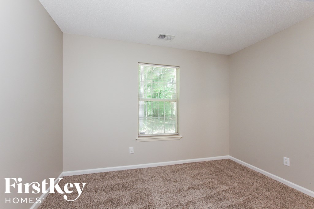 a room with carpet and a window in it