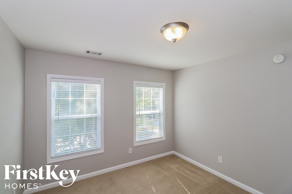 A room with two windows and a FirstKey Homes logo.