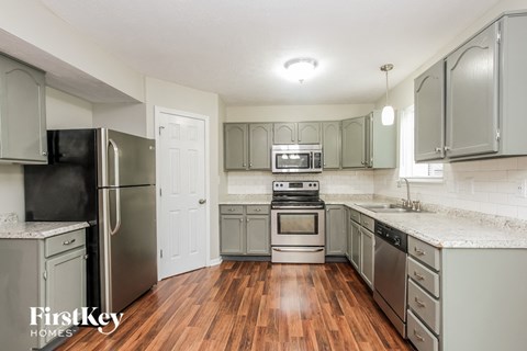 A kitchen with wooden floors and stainless steel appliances.