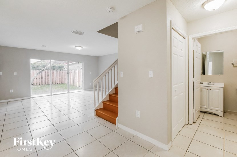 the foyer and living room with stairs to the upper level