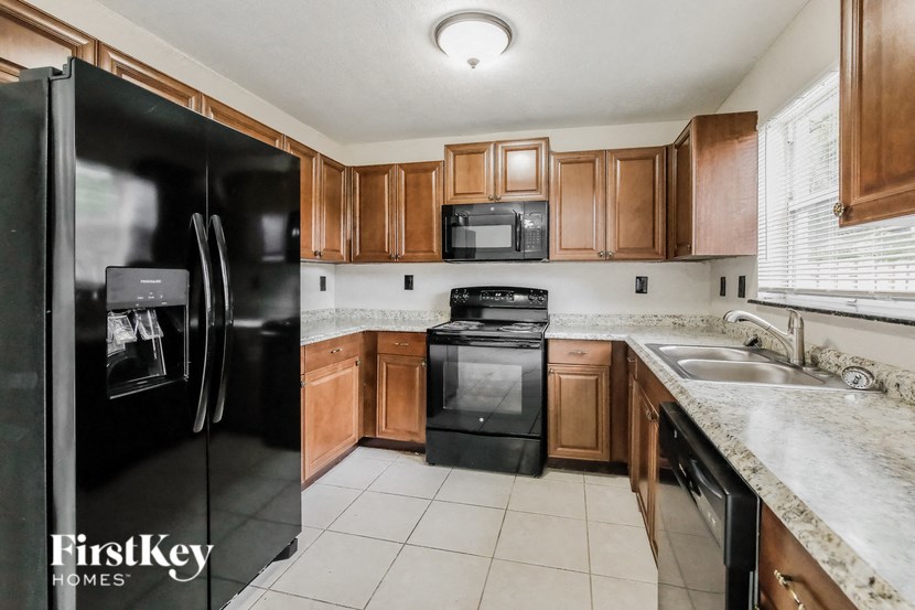 a kitchen with wooden cabinets and black appliances