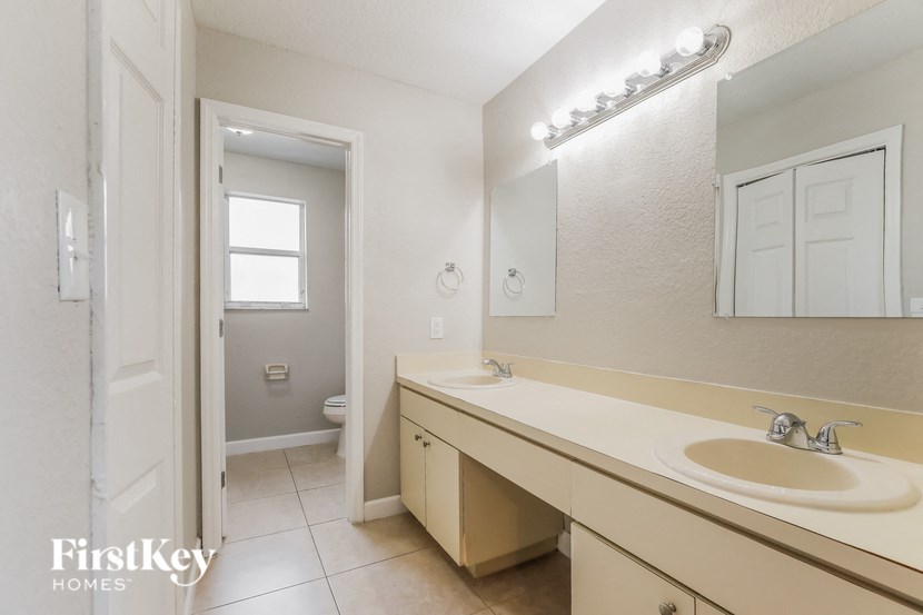 a bathroom with a sink and a mirror and a toilet