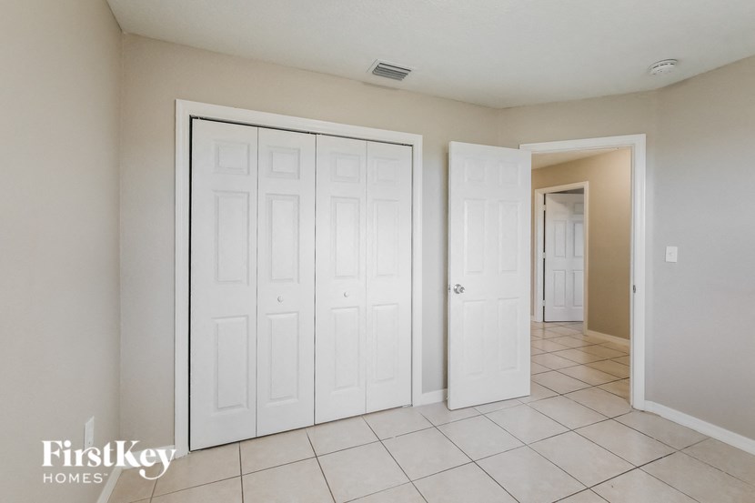 a room with two closets and a door to a hallway