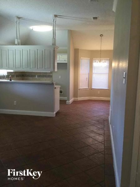 A kitchen with a white cabinet and a stove top oven.