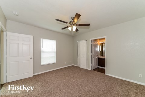 the master bedroom is spacious and has a ceiling fan