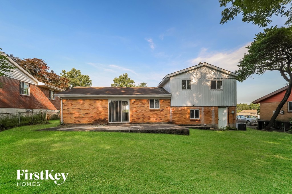 A house with a large lawn in front of it.