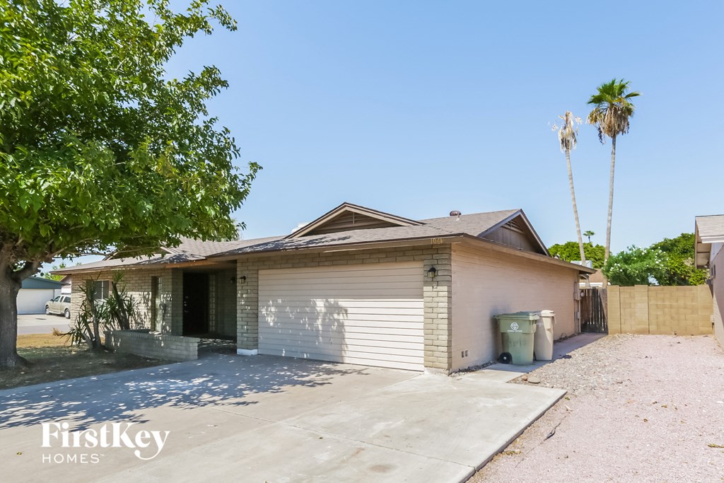 a small house with a driveway and a garage door