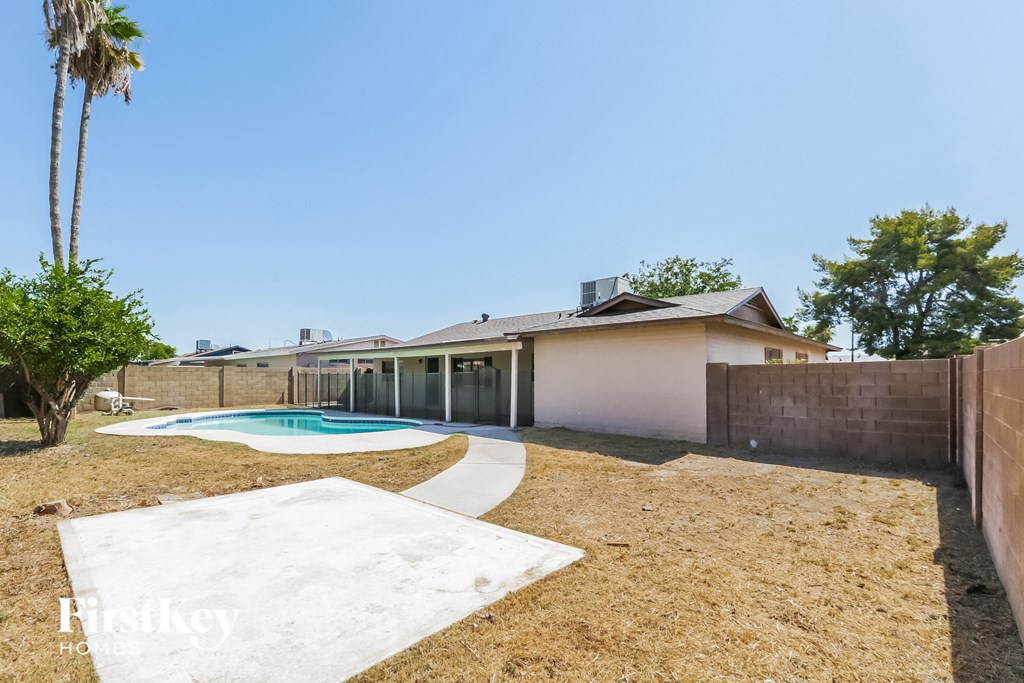 a backyard with a pool and a house