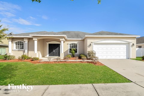 a beige house with a white garage door