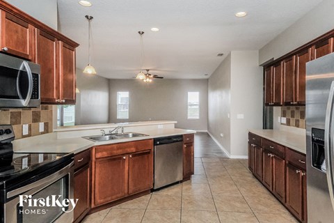 a kitchen with wooden cabinets and stainless steel appliances