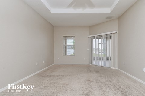 a spacious living room with carpet and a large window