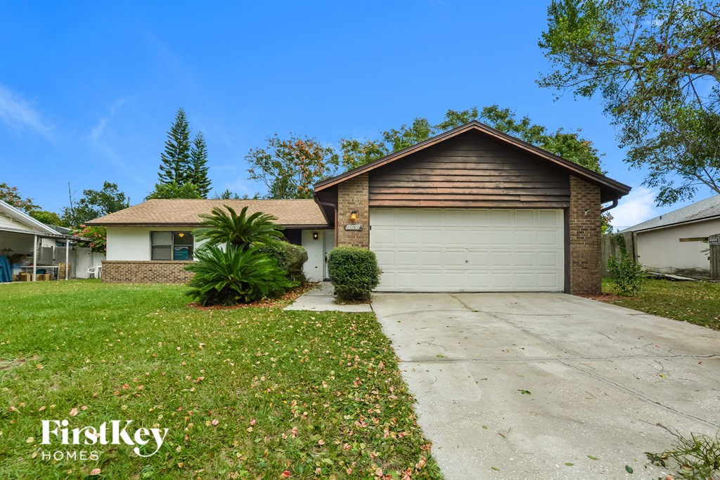 a home with a white garage door and a driveway
