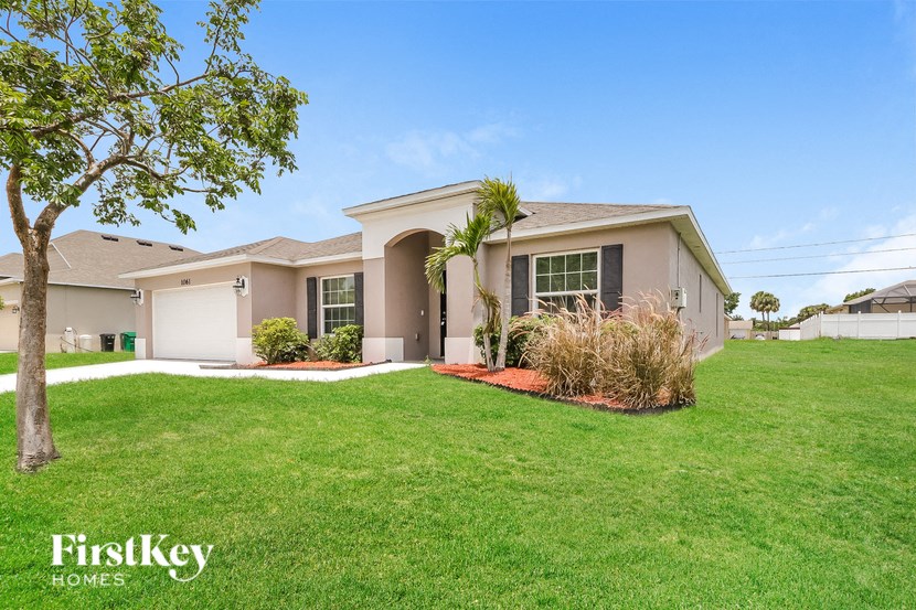 a house with a lawn and a palm tree