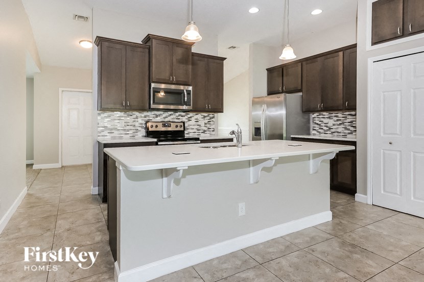 a kitchen with a large white counter top