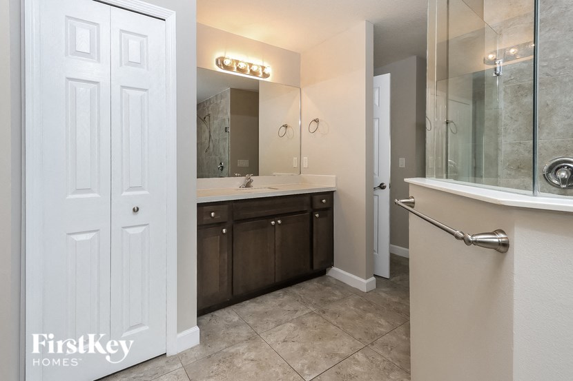 a bathroom with a sink and a mirror and a shower