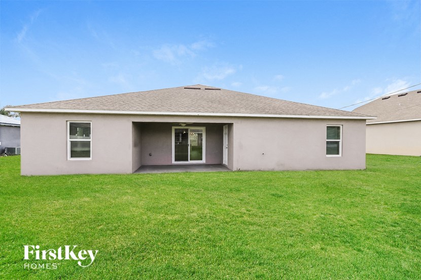 a white house with a green lawn in front of it