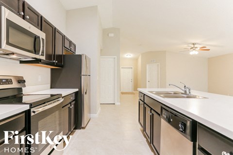 A kitchen with a FirstKey Homes logo.