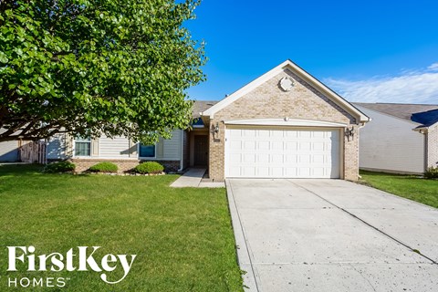 a white brick house with a white garage door