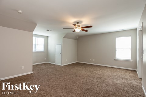 a bedroom with carpet and a ceiling fan